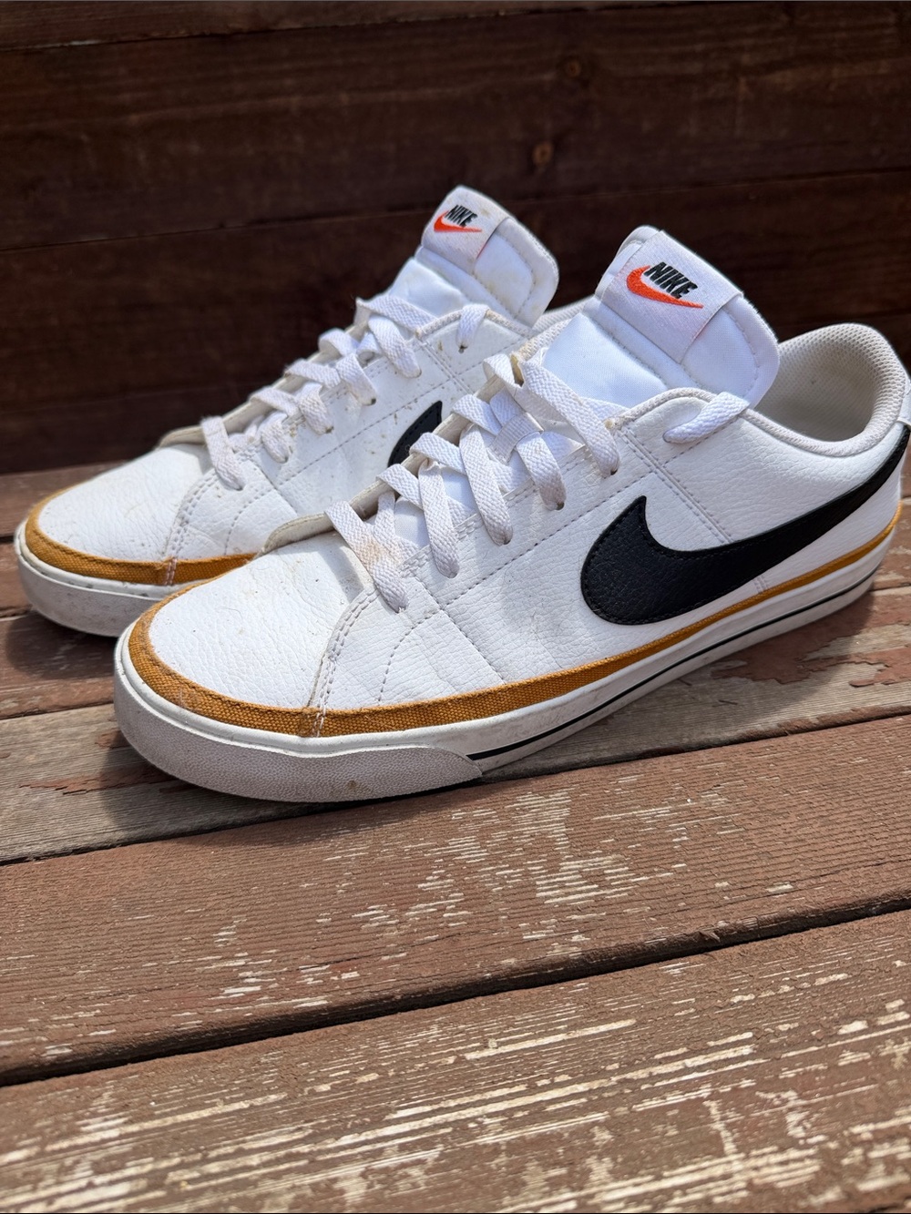 Nike Men’s White Sneakers with Black Swoosh and Gold Accent